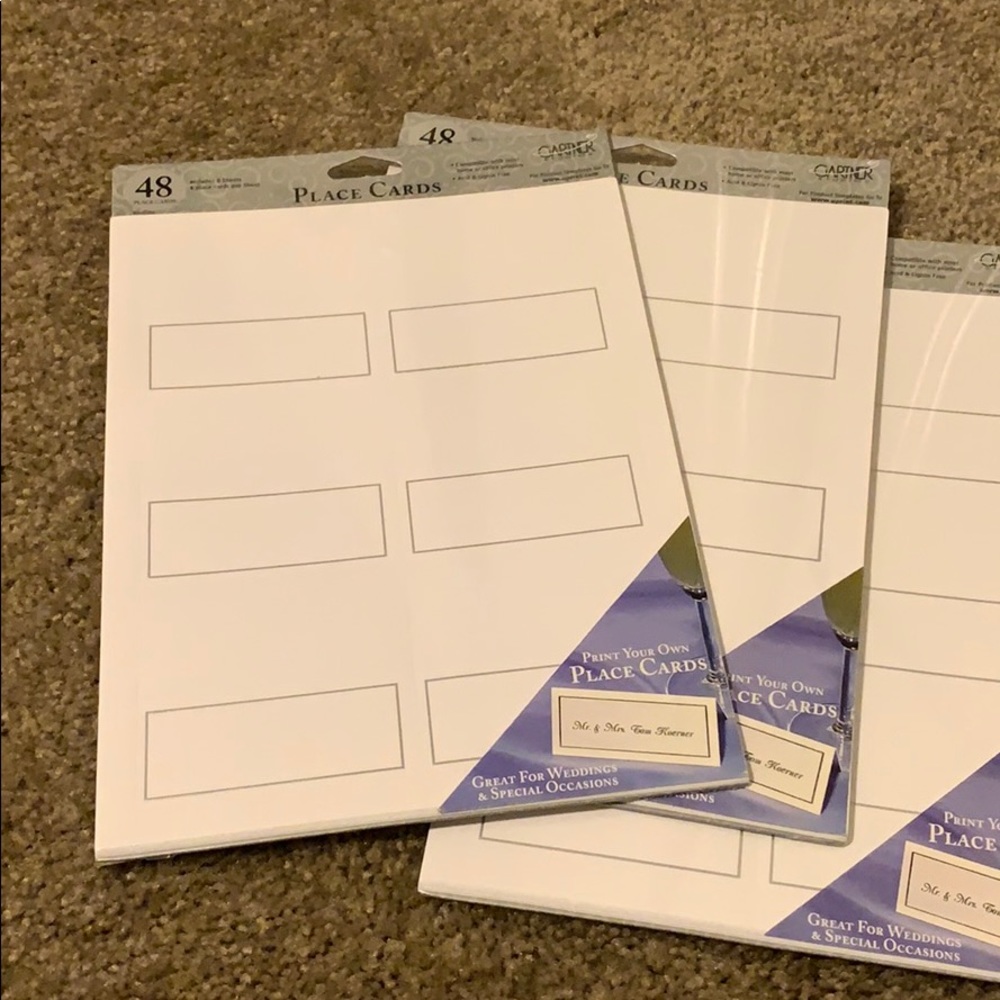 White and silver place card holders.